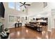Bright and airy living room featuring high ceilings, large windows, and hardwood floors at 4070 Preserve Crossing Ln, Cumming, GA 30040