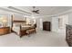 Spacious primary bedroom boasts tray ceilings, furniture, and multiple doorways at 4070 Preserve Crossing Ln, Cumming, GA 30040