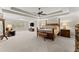 Spacious main bedroom with tray ceiling, ceiling fan, sitting area, and furniture at 4070 Preserve Crossing Ln, Cumming, GA 30040