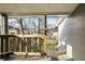 Covered back porch overlooking a spacious backyard with mature trees and partial fence at 1084 Kirkwood Se Ave, Atlanta, GA 30316