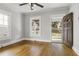 Sunlit living room features gleaming hardwood floors, fresh paint, and a classic front door at 1084 Kirkwood Se Ave, Atlanta, GA 30316