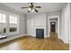 Bright living room featuring hardwood floors, a decorative fireplace, and a modern ceiling fan at 1084 Kirkwood Se Ave, Atlanta, GA 30316