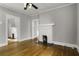 Spacious living room with hardwood floors and a bright fireplace, offering a classic and inviting space at 1084 Kirkwood Se Ave, Atlanta, GA 30316