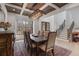 Elegant dining room with staircase, decorative wood paneled ceiling, chandelier, and black trimmed windows at 120 Nezhat Pl, Atlanta, GA 30350