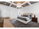 Relaxing bedroom with tufted headboard, decorative rug, and access to the attached primary bathroom at 120 Nezhat Pl, Atlanta, GA 30350