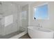 Luxurious bathroom featuring a soaking tub and glass-enclosed shower at 481 Hammons Way, Atlanta, GA 30315