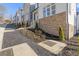 Street view showing the modern townhome architecture with stone accents and professionally landscaped front yard at 481 Hammons Way, Atlanta, GA 30315