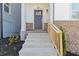 Inviting front entrance with stone accents and a light gray front door leading to this charming home at 481 Hammons Way, Atlanta, GA 30315