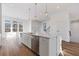 Open concept kitchen features stainless steel appliances, a spacious island, and natural light at 481 Hammons Way, Atlanta, GA 30315