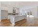 A stylish kitchen featuring white cabinets, a kitchen island, and modern pendant lighting at 481 Hammons Way, Atlanta, GA 30315