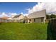 Spacious backyard featuring a well-kept lawn, offering ample space for recreation and outdoor activities in a private setting at 260 Shadowbrooke Dr, Loganville, GA 30052