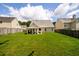 Spacious backyard with lush green grass and a covered patio at 260 Shadowbrooke Dr, Loganville, GA 30052