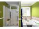 Bathroom featuring a shower and a soaking tub with decorative tile and green painted walls at 260 Shadowbrooke Dr, Loganville, GA 30052