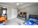 Bedroom with a crib and toddler bed, ceiling fan, and neutral carpet at 260 Shadowbrooke Dr, Loganville, GA 30052