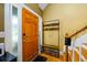 Welcoming entryway featuring a coat rack with bench and a staircase leading to the upper level at 260 Shadowbrooke Dr, Loganville, GA 30052