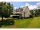 Lovely single-Gathering home featuring a manicured lawn and mature trees, with an attached garage at 260 Shadowbrooke Dr, Loganville, GA 30052