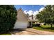Suburban home with a two-car garage and a well-maintained lawn on a sunny day at 260 Shadowbrooke Dr, Loganville, GA 30052