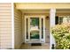 Inviting front entrance with a glass door, decorative sidelights, and manicured bushes at 260 Shadowbrooke Dr, Loganville, GA 30052