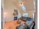 Vaulted living room featuring hardwood floors, a fireplace, and large windows for natural light at 260 Shadowbrooke Dr, Loganville, GA 30052
