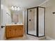 Bathroom showcasing a glass-enclosed shower and vanity with wood cabinets at 351 Allendale Dr, Canton, GA 30115
