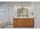 Bathroom with double sink vanity, large mirror, tile floor, and separate doors to toilet and shower at 351 Allendale Dr, Canton, GA 30115