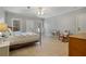 Spacious bedroom with neutral walls, tile floors, and a comfortable rocking chair at 351 Allendale Dr, Canton, GA 30115
