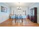 Formal dining room featuring wood floors, wainscoting, and elegant chandelier at 351 Allendale Dr, Canton, GA 30115