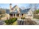 Two-story home boasts stone accents, a cozy front porch and mature landscaping at 351 Allendale Dr, Canton, GA 30115
