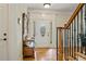 Inviting foyer with hardwood floors, a decorative front door, staircase, and a charming antique bench with coat rack at 351 Allendale Dr, Canton, GA 30115