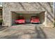 Spacious garage showcasing a classic red truck and vintage red sports car at 351 Allendale Dr, Canton, GA 30115