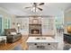 Cozy living room features a stone fireplace, custom built-in shelves, and hardwood floors with outside view at 351 Allendale Dr, Canton, GA 30115