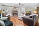 Comfortable living room features a stone fireplace, built-in bookcases, and hardwood floors, ideal for relaxation and entertaining at 351 Allendale Dr, Canton, GA 30115