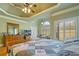 Comfortable main bedroom with ceiling fan, trey ceiling, shuttered windows, and a view of the backyard at 351 Allendale Dr, Canton, GA 30115