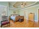 Spacious main bedroom with a trey ceiling, light hardwood floors, and a large window with shutters at 351 Allendale Dr, Canton, GA 30115