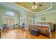 Lovely main bedroom with tray ceiling, wooden floors, and shuttered windows providing ample natural light at 351 Allendale Dr, Canton, GA 30115