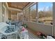 Relaxing screened porch with wood paneled ceiling and multiple seating areas overlooking the wooded backyard at 351 Allendale Dr, Canton, GA 30115