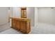 Wet bar in the basement features wood cabinetry, countertop and a small overhead cabinet at 4125 Gables Pl, Buford, GA 30519
