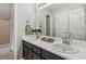Bathroom featuring double sinks, sleek cabinets, and a large mirror reflecting natural light at 4125 Gables Pl, Buford, GA 30519