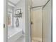Bright bathroom with a soaking tub, separate shower, and a large window providing natural light at 4125 Gables Pl, Buford, GA 30519