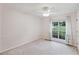 Bright bedroom features neutral carpet, large windows with a treed view, and light paint at 4125 Gables Pl, Buford, GA 30519