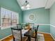 Inviting dining room with ample natural light, featuring a decorative light fixture and painted green walls at 4125 Gables Pl, Buford, GA 30519