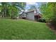 Exterior of home with multiple wood decks and lush backyard at 4125 Gables Pl, Buford, GA 30519