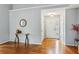 Inviting foyer with hardwood floors, white trim, and a decorative mirror and table at 4125 Gables Pl, Buford, GA 30519