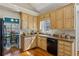 Updated kitchen featuring granite counters, stainless appliances, and hardwood floors with ample storage at 4125 Gables Pl, Buford, GA 30519