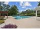 Community pool with pergola and ample concrete decking with easy access and lush landscaping at 4125 Gables Pl, Buford, GA 30519