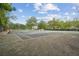 Community tennis court with mature landscaping and seating at 4125 Gables Pl, Buford, GA 30519