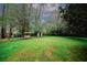 Lush backyard with swing set and storage shed, providing ample space for recreation and outdoor storage at 4144 Hideaway Dr, Tucker, GA 30084