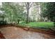A backyard with brick patio and mature trees at 4144 Hideaway Dr, Tucker, GA 30084