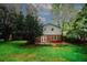 Exterior view of the backyard with a well-maintained lawn, patio area, and mature trees providing privacy and shade at 4144 Hideaway Dr, Tucker, GA 30084