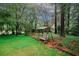 Secluded backyard with mature trees and a charming swing bench, perfect for relaxation at 4144 Hideaway Dr, Tucker, GA 30084